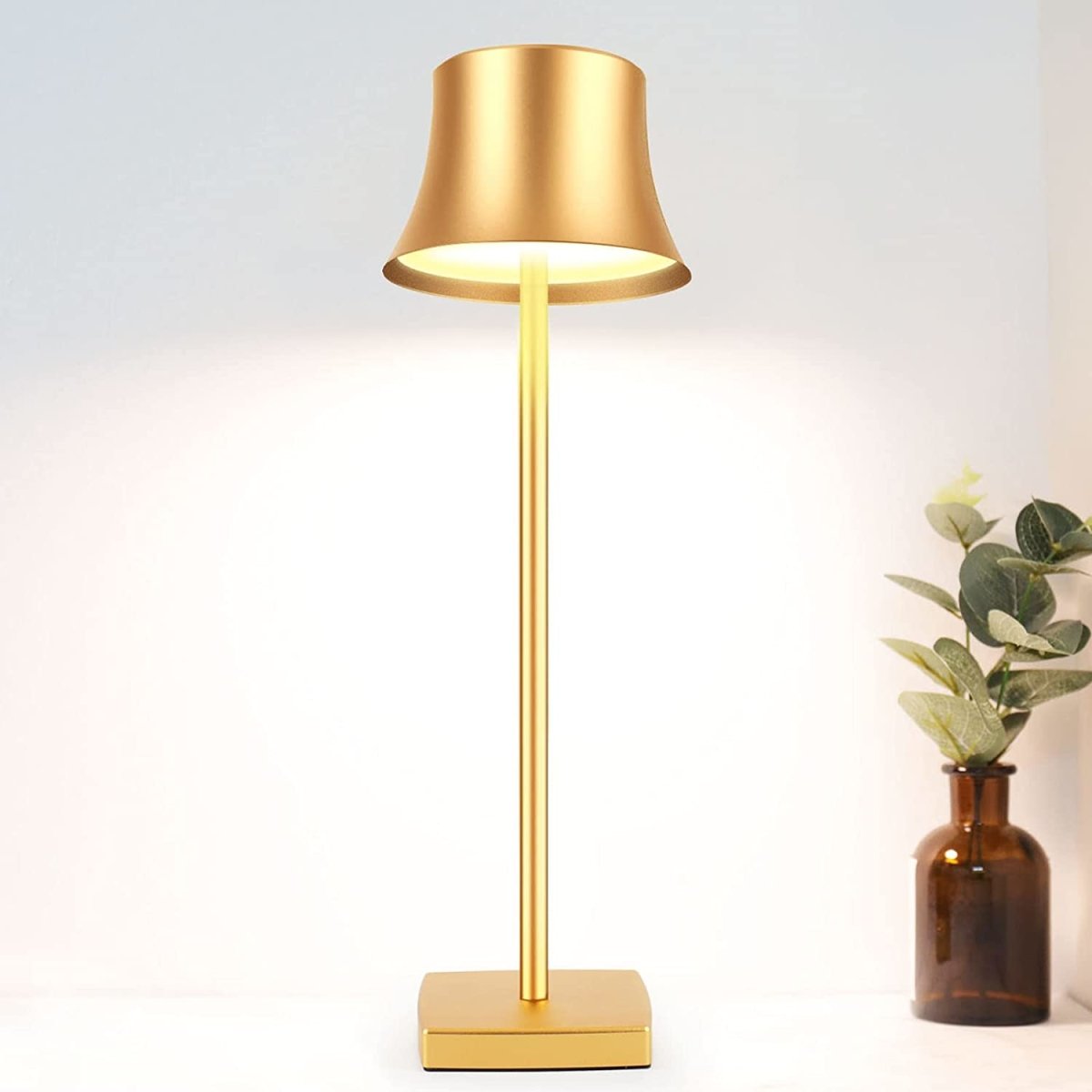 Cordless touch table lamp on a bedside table with soft warm light