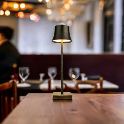 Cordless touch table lamp on a bedside table with soft warm light