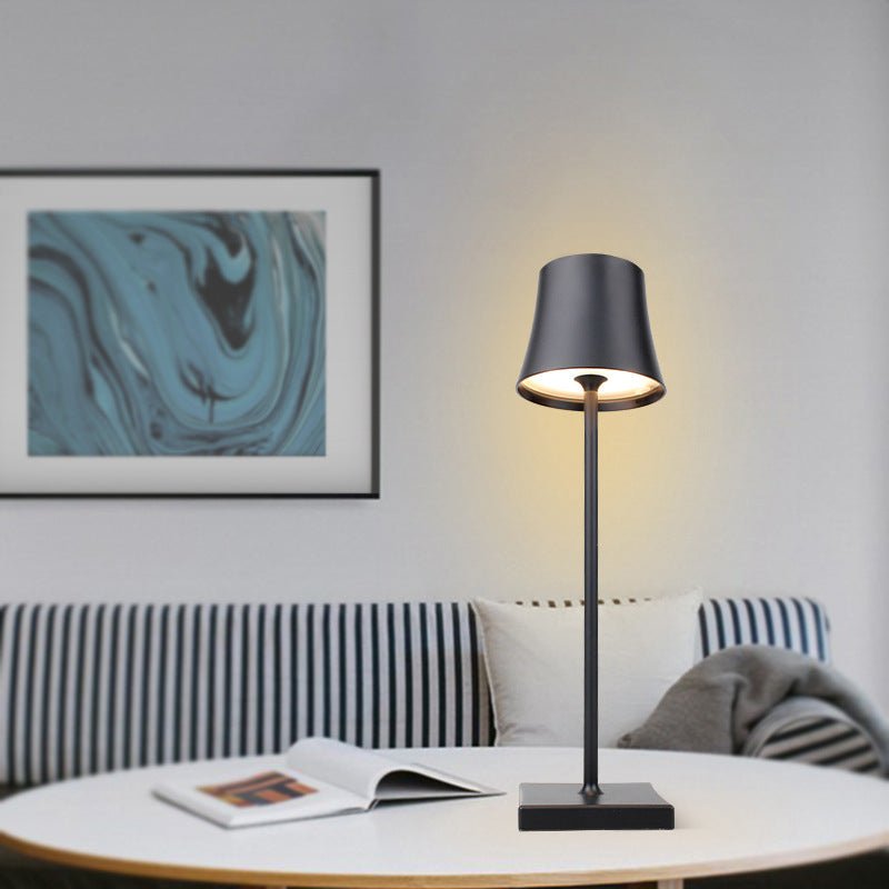 Cordless touch table lamp on a bedside table with soft warm light