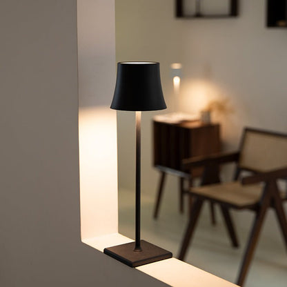 Cordless touch table lamp on a bedside table with soft warm light