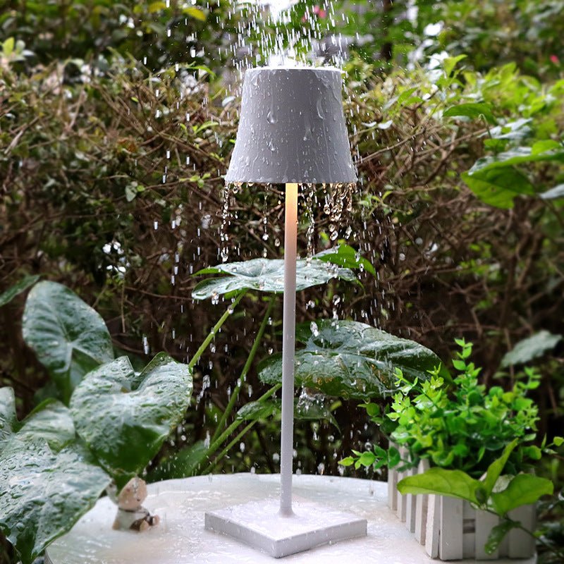 Cordless touch table lamp on a bedside table with soft warm light