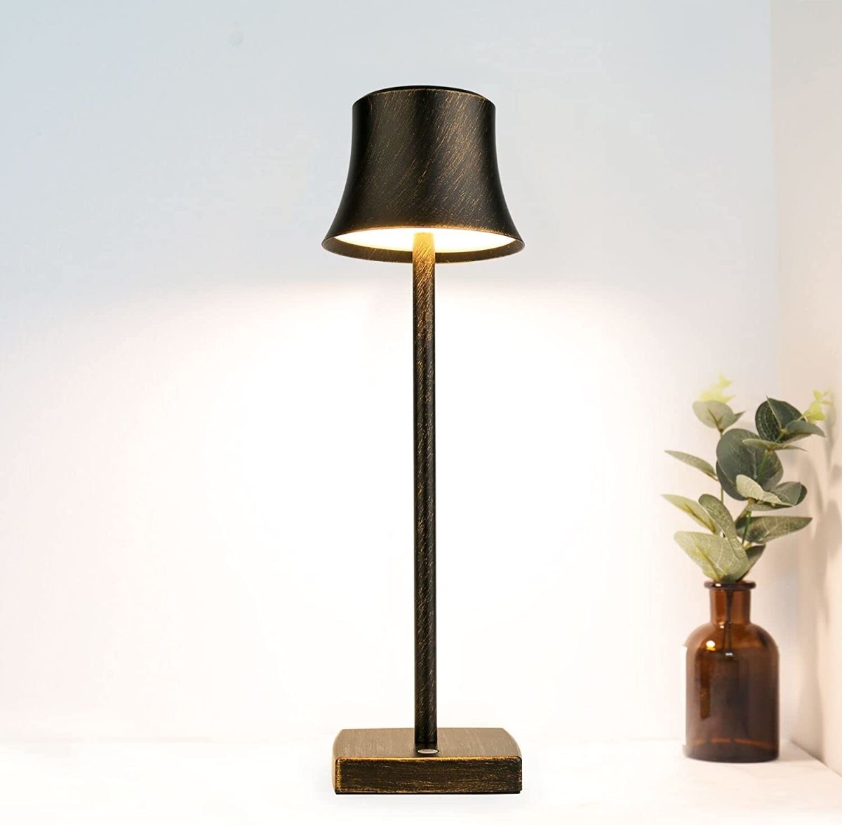 Cordless touch table lamp on a bedside table with soft warm light