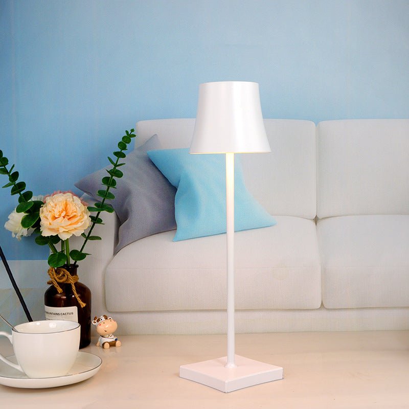 Cordless touch table lamp on a bedside table with soft warm light