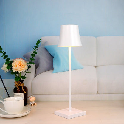 Cordless touch table lamp on a bedside table with soft warm light