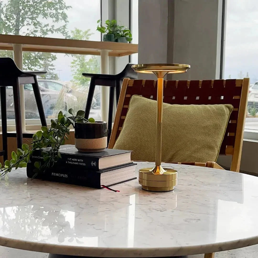 Cordless table lamp with aluminum body on an outdoor dining table