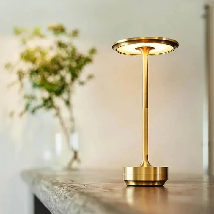 Cordless table lamp with aluminum body on an outdoor dining table