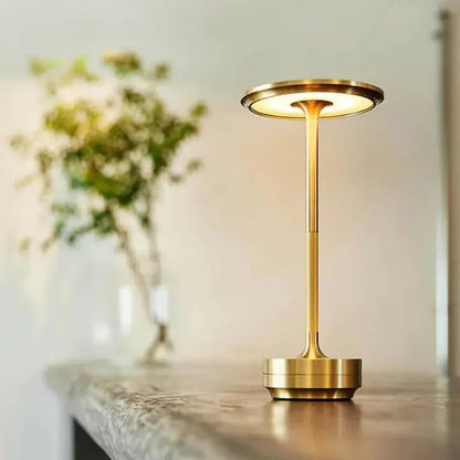 Cordless table lamp with aluminum body on an outdoor dining table