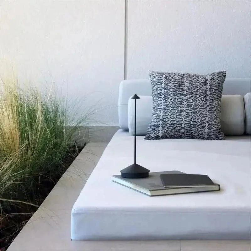 Cordless table lamp with warm ambient light on a patio, no cords