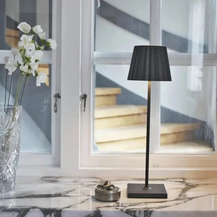 Cordless waterproof LED table lamp on a patio table for outdoor entertaining