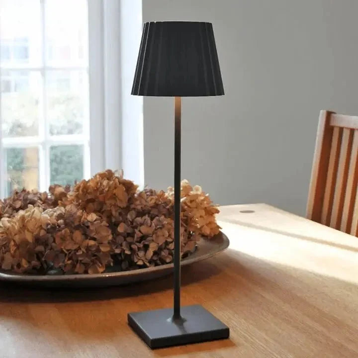 Cordless waterproof LED table lamp on a patio table for outdoor entertaining