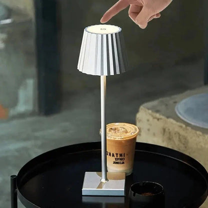 Cordless waterproof LED table lamp on a patio table for outdoor entertaining
