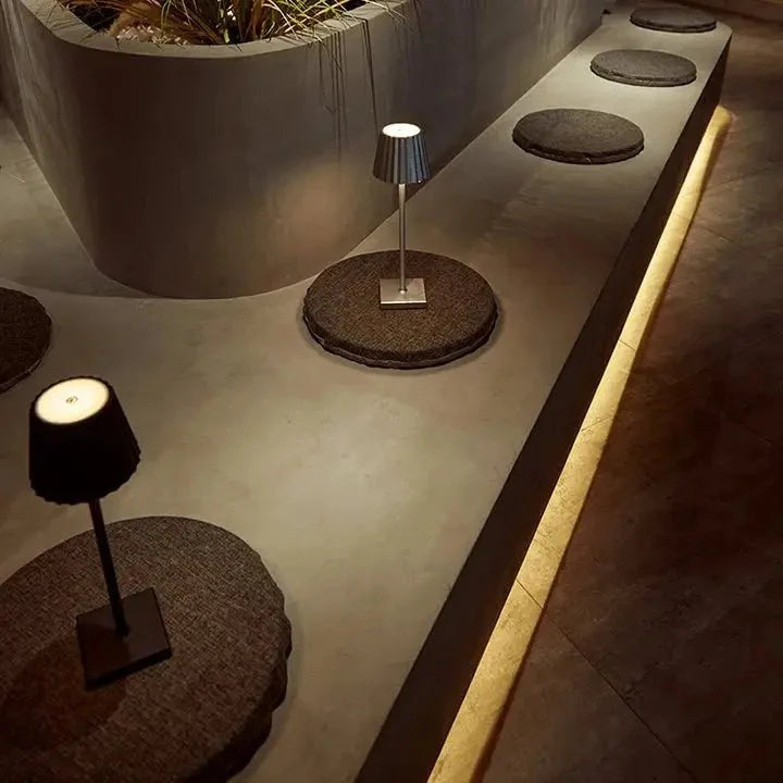 Cordless waterproof LED table lamp on a patio table for outdoor entertaining
