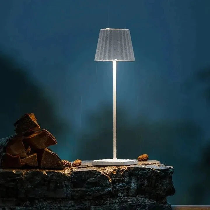 Cordless waterproof LED table lamp on a patio table for outdoor entertaining