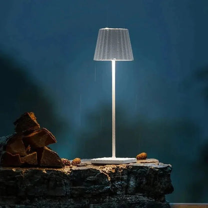 Cordless waterproof LED table lamp on a patio table for outdoor entertaining