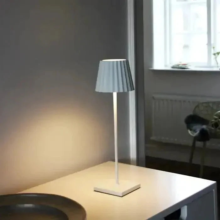 Cordless waterproof LED table lamp on a patio table for outdoor entertaining