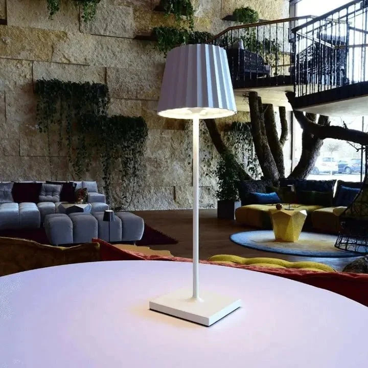 Cordless waterproof LED table lamp on a patio table for outdoor entertaining
