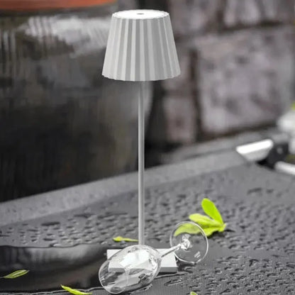Cordless waterproof LED table lamp on a patio table for outdoor entertaining