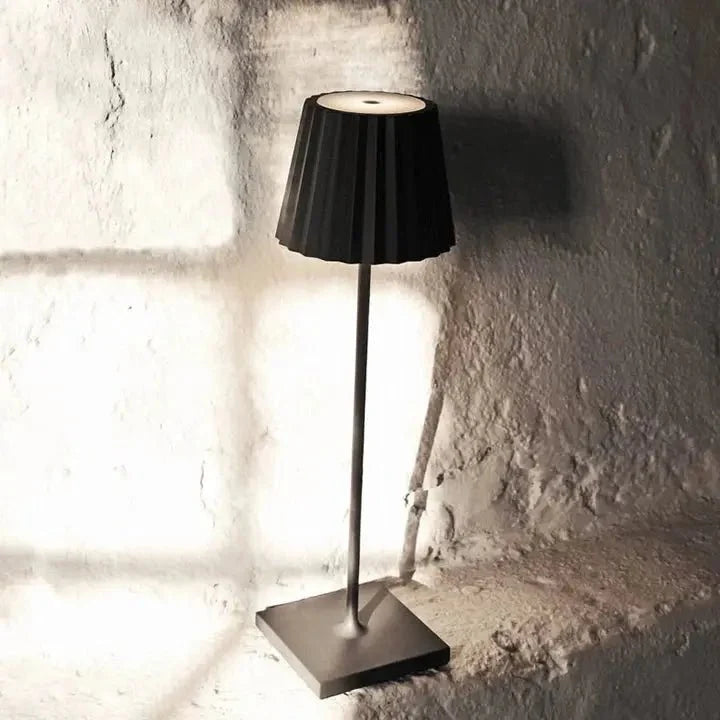Cordless waterproof LED table lamp on a patio table for outdoor entertaining
