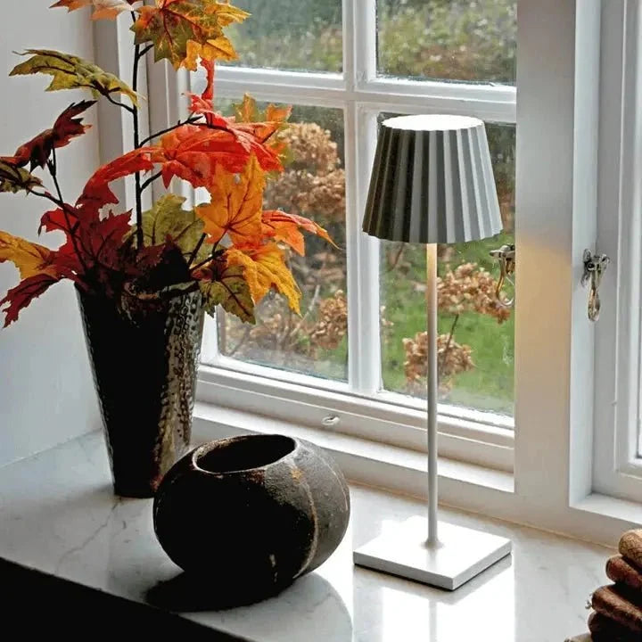Cordless waterproof LED table lamp on a patio table for outdoor entertaining