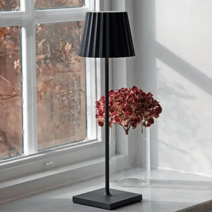 Cordless waterproof LED table lamp on a patio table for outdoor entertaining