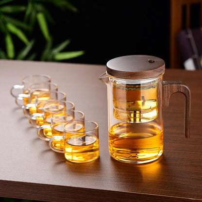 Glass teapot with one-press straining mechanism for loose-leaf tea