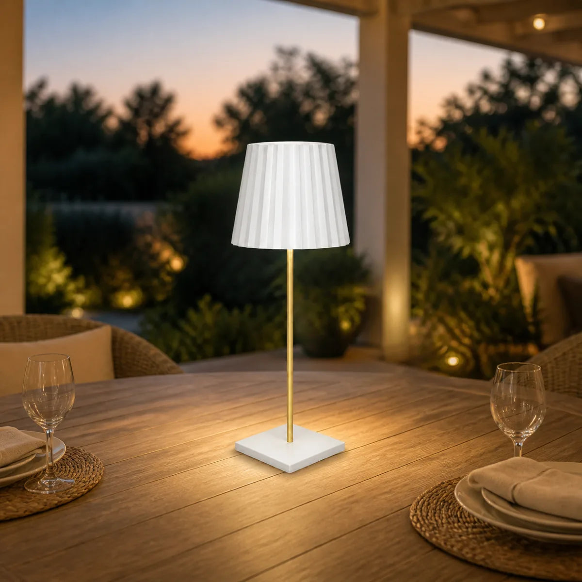 White rechargeable outdoor dining table lamp at dusk