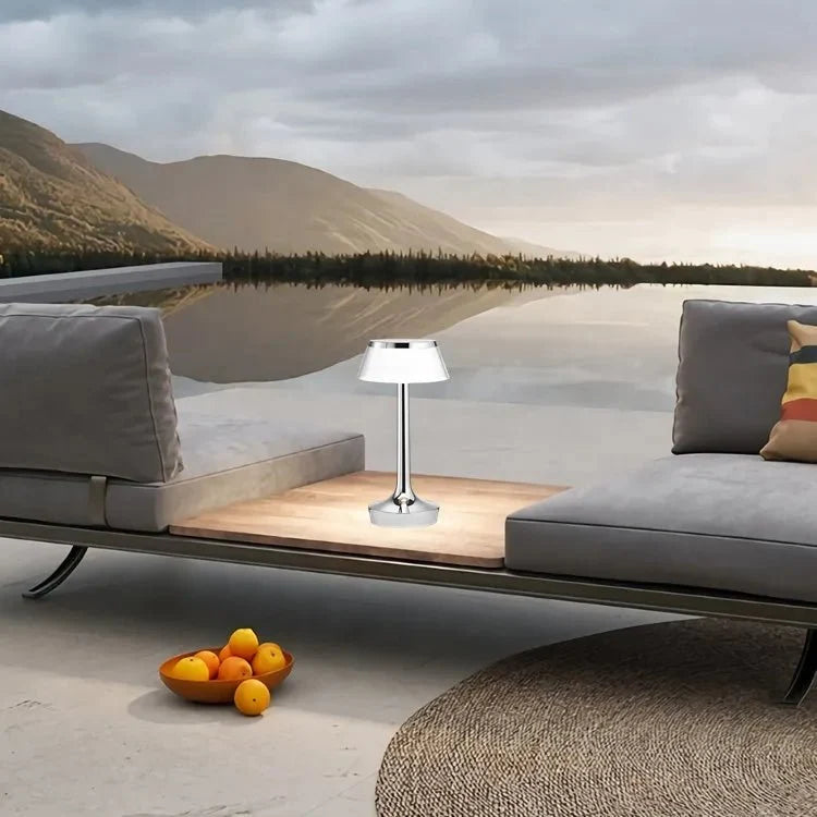 Cordless touch-controlled table lamp with warm glow on a nightstand in an apartment