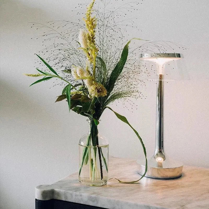 Cordless touch-controlled table lamp with warm glow on a nightstand in an apartment