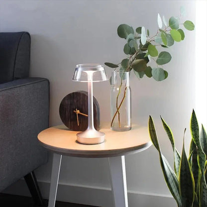 Cordless touch-controlled table lamp with warm glow on a nightstand in an apartment