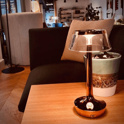 Cordless touch-controlled table lamp with warm glow on a nightstand in an apartment