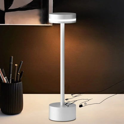 Portable cordless table lamp with aluminum body and round shade for camping and outdoor use