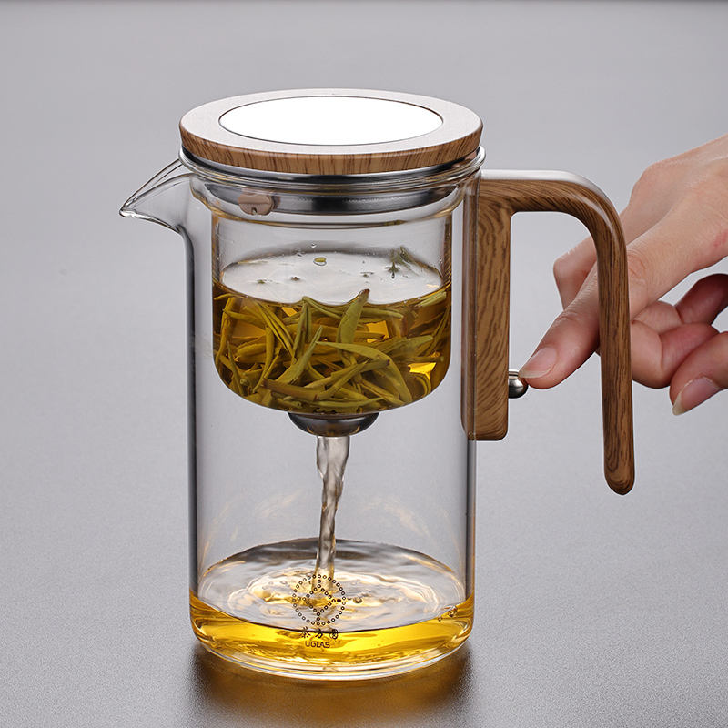 Glass teapot with one-press straining mechanism for loose-leaf tea
