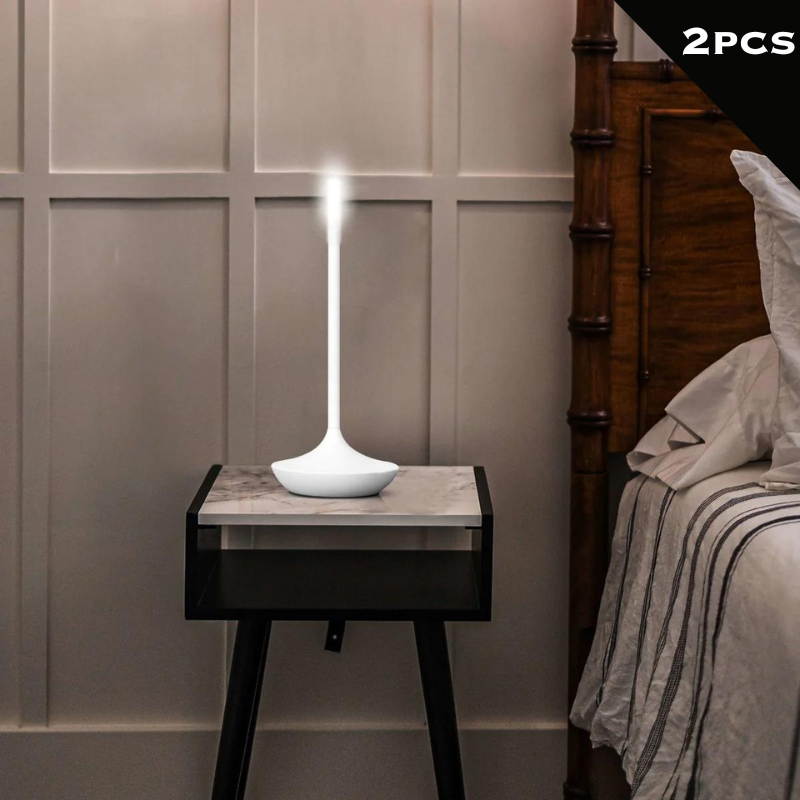 Rechargeable portable LED candle lamp with warm amber glow on a table, suitable for indoor and outdoor ambiance